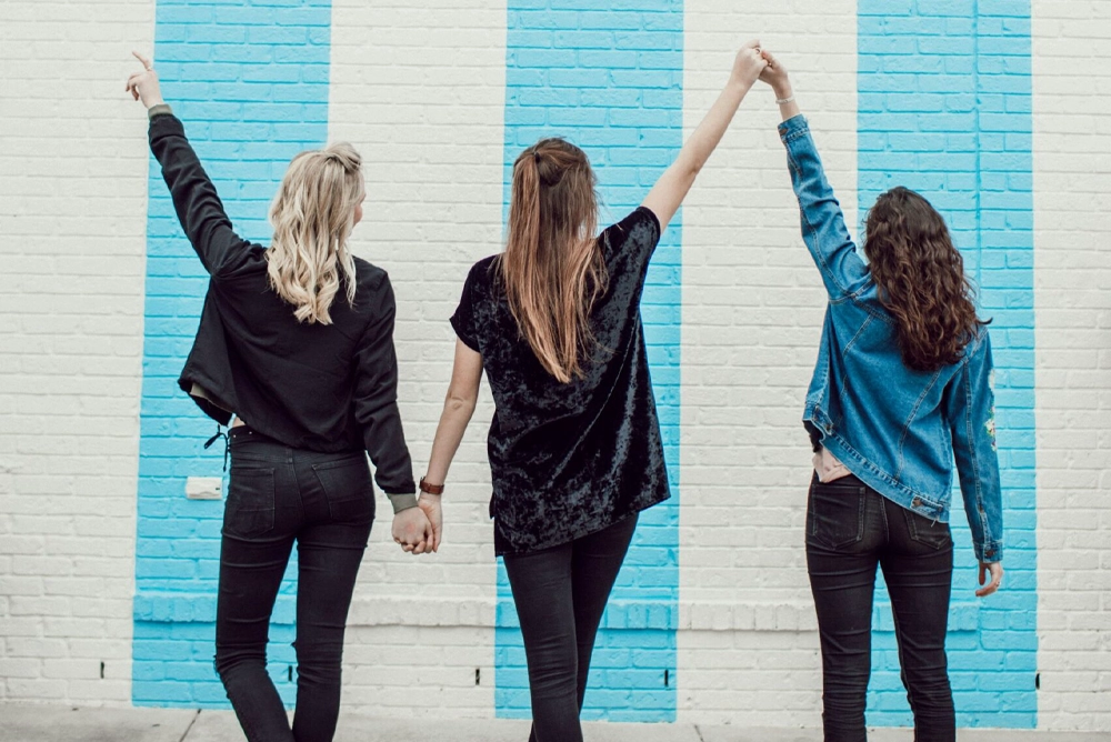 group of women holding hands